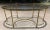 Neoclassical Jansen style brass and glass elliptical coffee table having large pinecone finials, manner of Maison Baguès,...