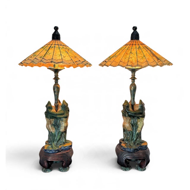 A pair of vintage Frederick Cooper lamps. Featuring three whimsical ceramic frogs with a sculptural base, each foot ending...