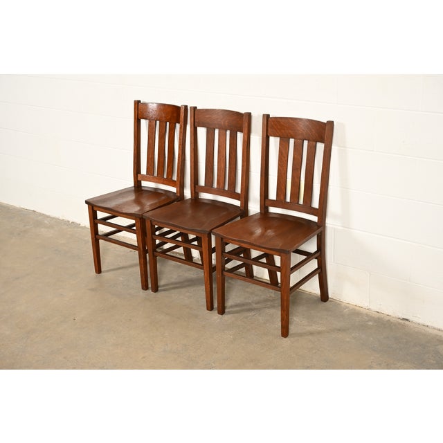 A gorgeous set of three antique Mission or Arts & Crafts period quarter sawn oak slat back side chairs or dining chairs In...