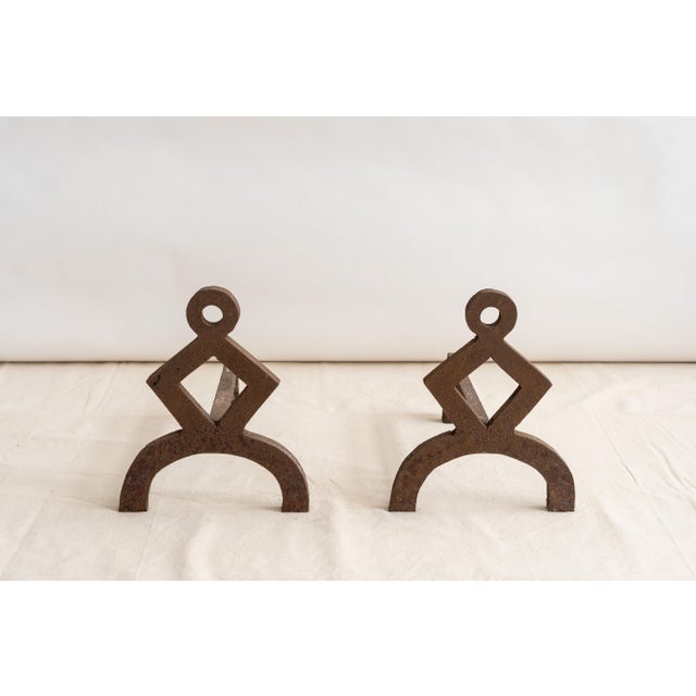 USA, ca. early 20th century. An unusual pair of andirons with strong geometric form. Each features heavy iron construction...