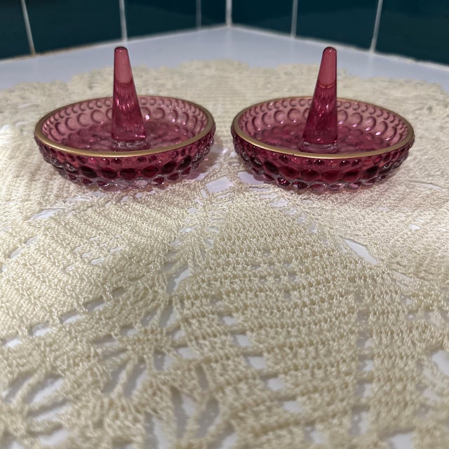Two beautiful vintage cranberry, gold rim. Hobnail ring holders or decor. In perfect condition. They were gifted to me by...