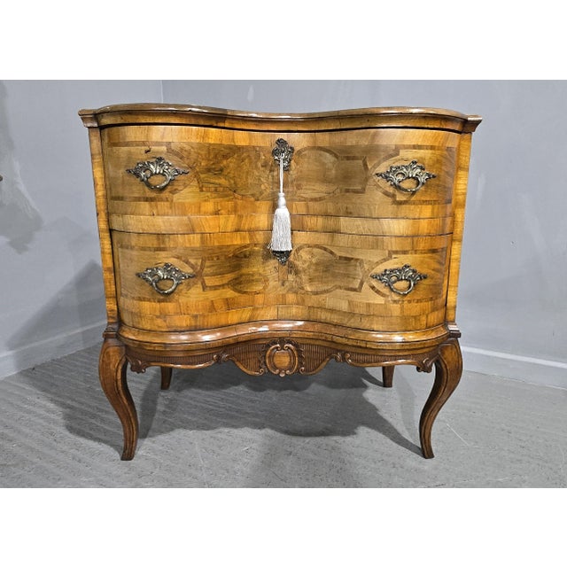 A super quality continental walnut two drawer deep serpentine chest of drawers, ioth gilt handles, cubb locks, standing on...