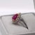 This stunning ring features a sparkling red Mozambizue ruby set in dual tone solid 14K rose and white gold with natural...