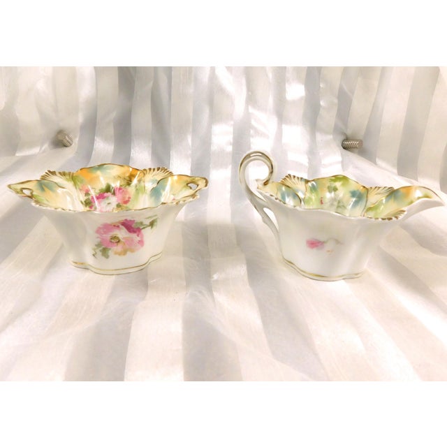 This is a Reinhold Schlegelmilch RS Prussia open sugar bowl and creamer in an unknown pattern. The set is white with a...