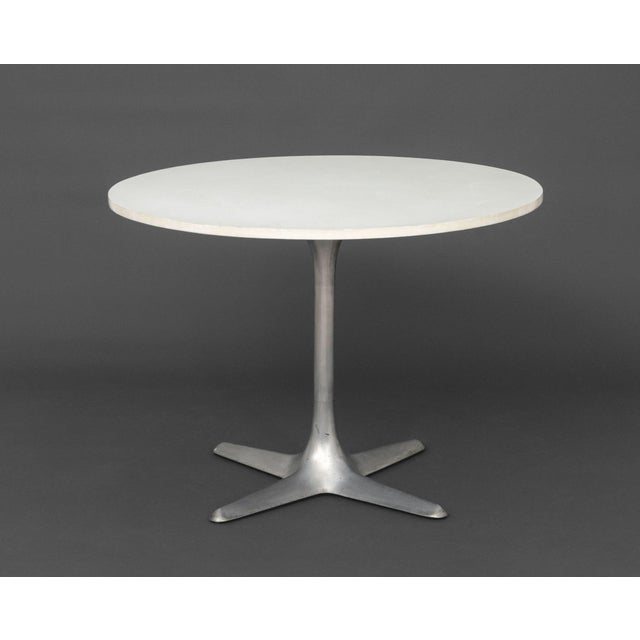 Mid-Century Modern White Laminate Circular Top Steel Center Table, the metal stem above a four-pointed star base. 29" H x...