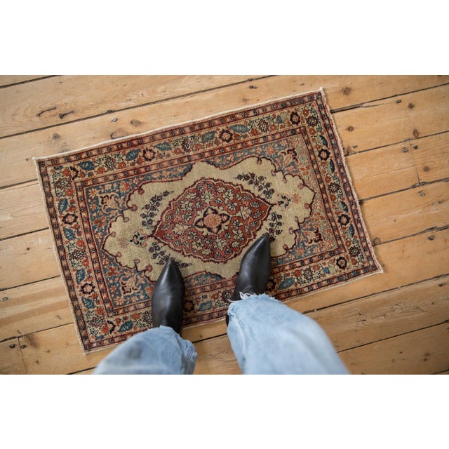 :: Scalloped center medallion in shield like relief bearing interior floral blossoms and minor finials atop a partially...