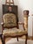 A beautiful antique French armchair in the Louis XV style, featuring a finely carved walnut frame, graceful cabriole legs,...