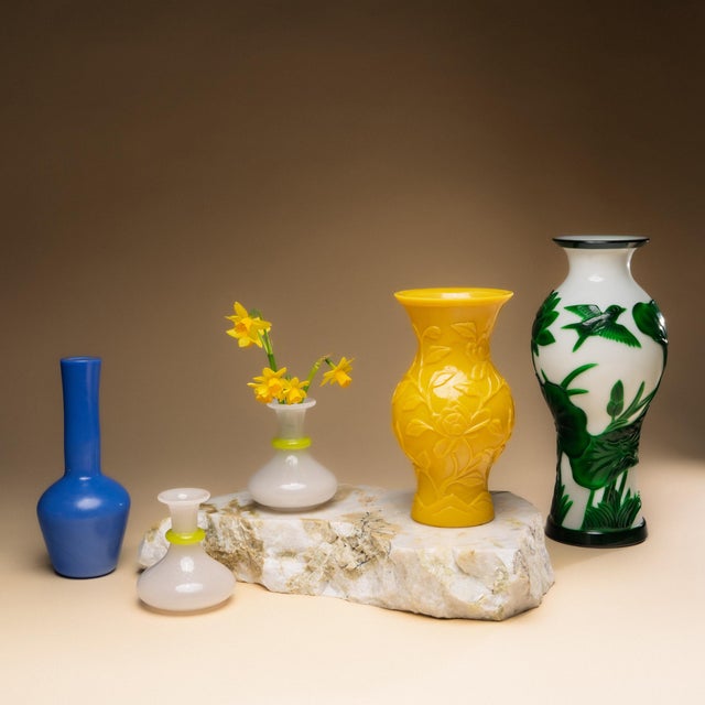 This petite pair of bud vases dates to the early 20th century and are elegantly shaped of white opaline glass with yellow...