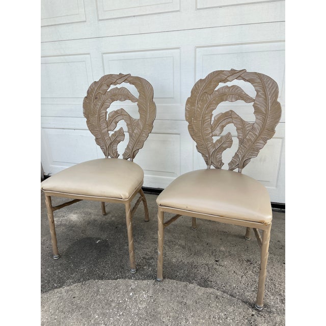 Set of 3 Vintage Hollywood Regency Cast Aluminum Dining Chairs with banana leaf motif. 2 have been painted taupe color and...