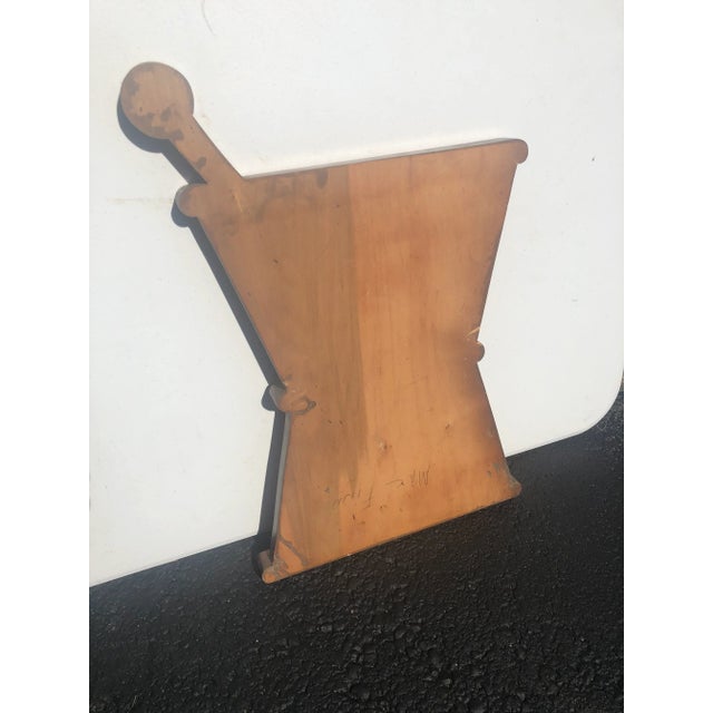 Mortar & pestil wooden drug store sign from Saratoga Springs, sat inside window, from the 20s, size 23”x 16”.