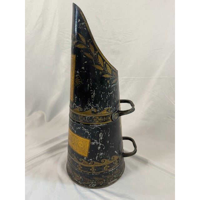 There's a wonderful graphic drama to this one: a black japanned coal helmet scuttle with gilt laurel swags, scrolling...