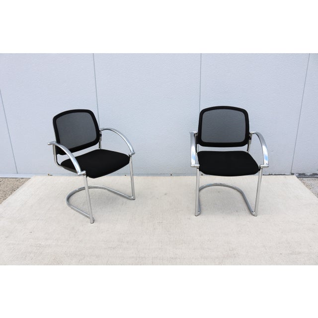 Fabulous pair of Open 30 ergonomic stacking guest chairs made in Germany by Topstar. These sleek chairs emphasize...