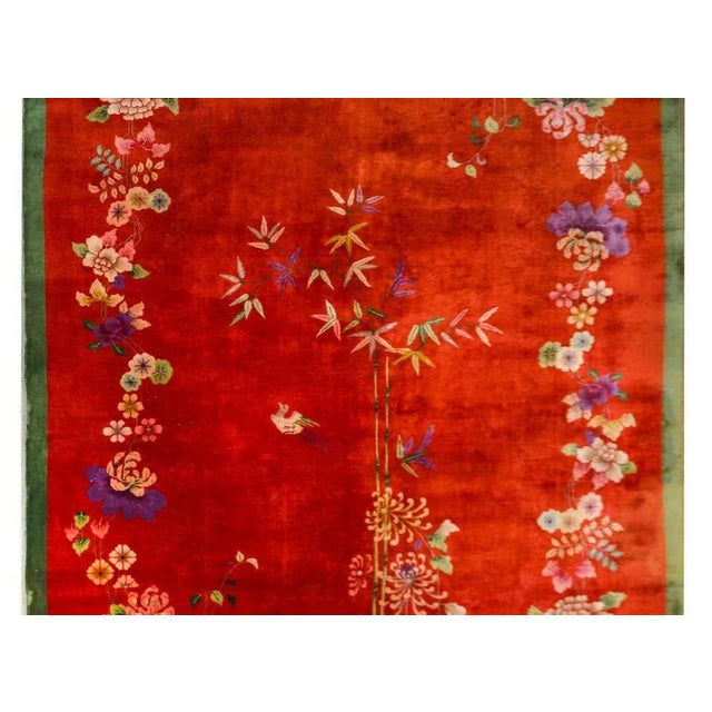 An exceptional early 20th century Chinese Art Deco rug with a bold red field surrounded by a thin green border. The field...
