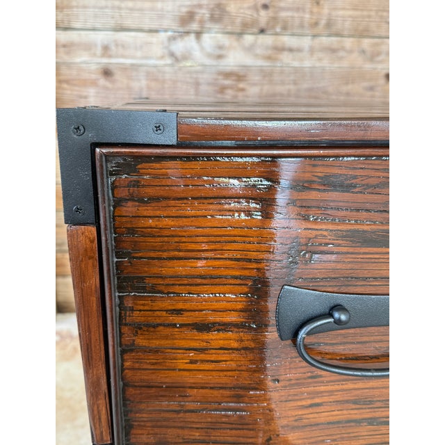 A striking pair of Campaign-inspired chests from the Acquisitions by Henredon collection, showcasing bold brass-style...