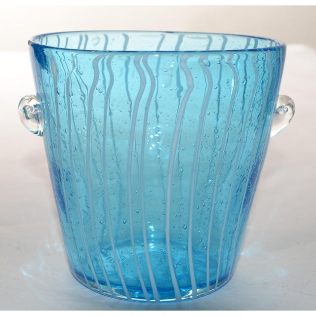 This 1970s Venini Murano Art Glass Ice bucket in a light blue hue with vertical white stripes and bubble detailing,...