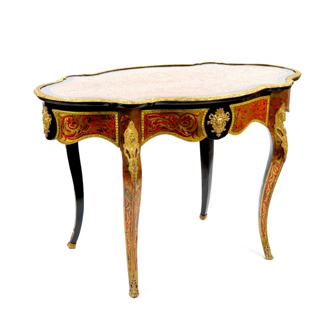 This magnificent 19th-century French Continental Boulle Desk / Center Table is a masterpiece of luxurious craftsmanship...