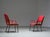 Set of Two Red Armchairs in Brass and Wood, Italy, 1960's These two chairs feature a black painted metal frame, smooth...