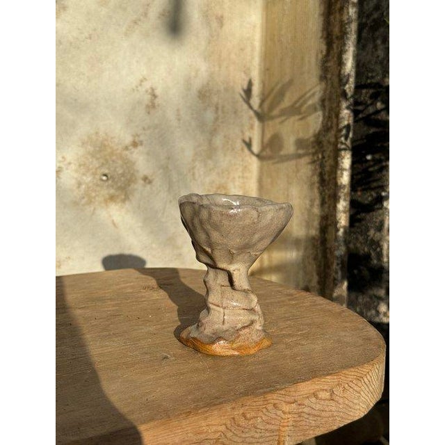 This Naïve Art Pottery Handmade Goblet, bearing the signature of Mary, is charming with a distinctive feature: the stem is...