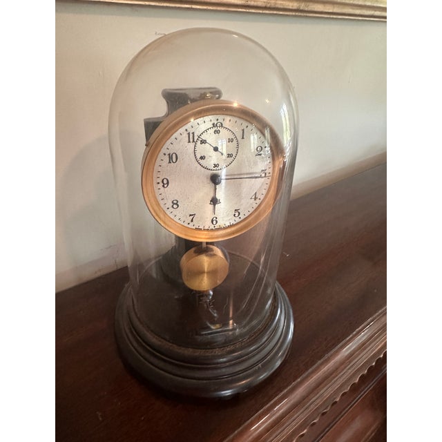 Early Poole electromechanical pendulum clock with a silvered Arabic dial, subsidiary seconds dial, exposed movement and...