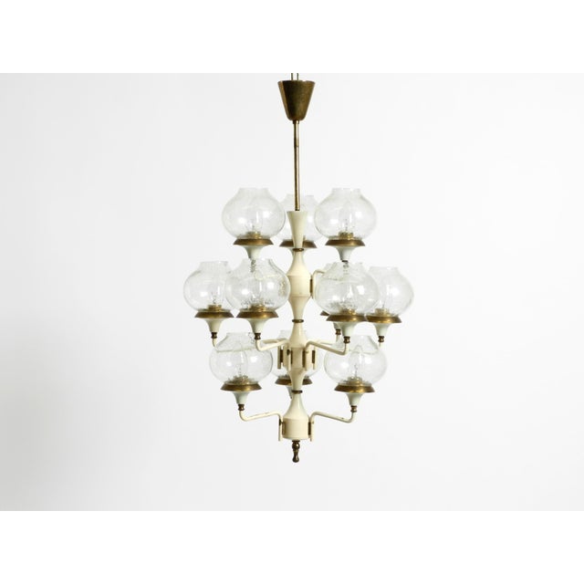 Beautiful 1960s metal and brass ceiling lamp with 12 arms. design by hans agne jakobsson. Manufacturer is markaryd. Made...