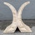 This postmodern table base transforms tessellated stone into a sculptural X-shaped form. Two concave arcs curve outward...