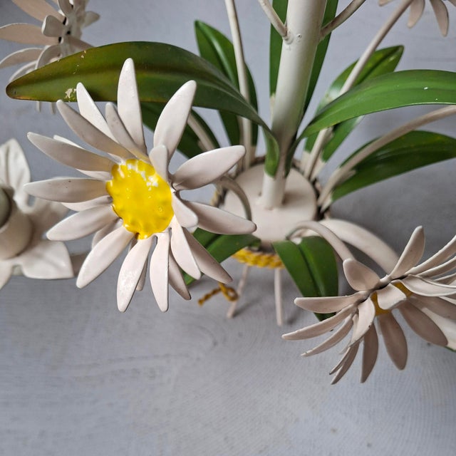 This French 1970s metal or toleware floral chandelier has 3 light fittings. European Plug (up to 250V).The wiring of this...