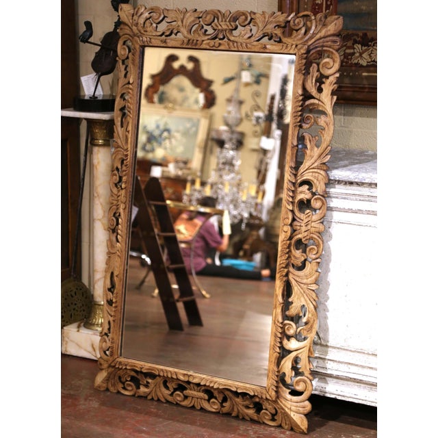 Richly carved with intricate Renaissance-inspired decoration, this antique French wall mirror showcases the craftsmanship...