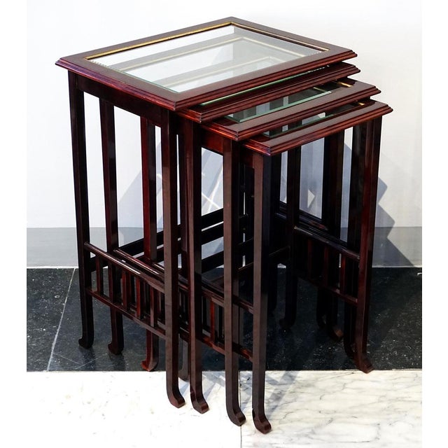 Elegant Art Nouveau side table set comprising four individual tables of varying sizes that slide into one another; each...