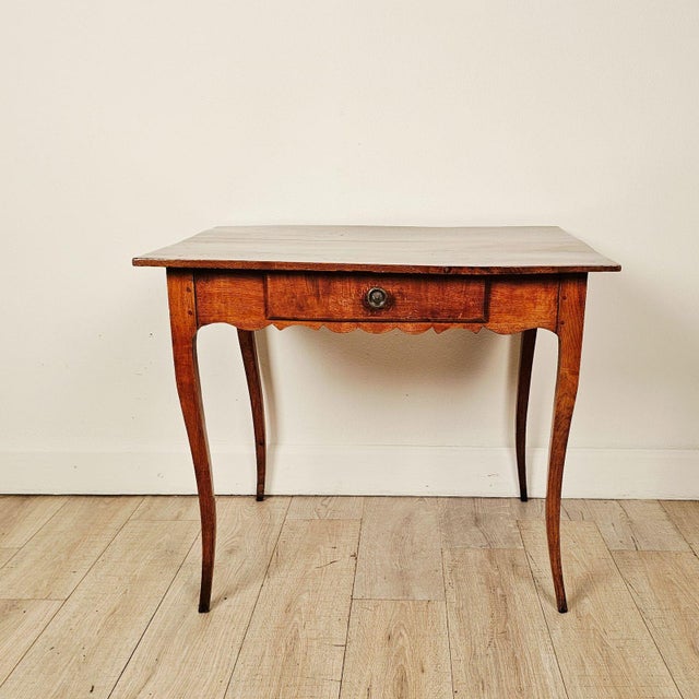 An 18th-century Louis XV cherry side table with drawer.