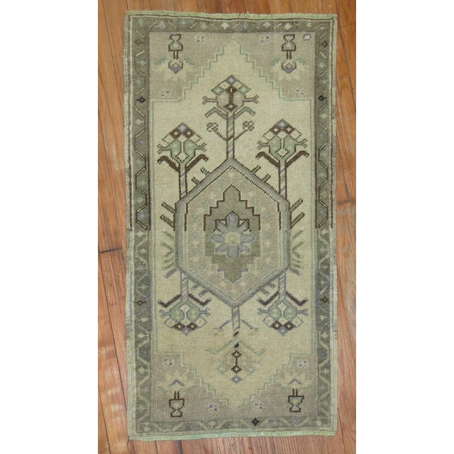 A mid 20th century neutral color turkish mini small rug