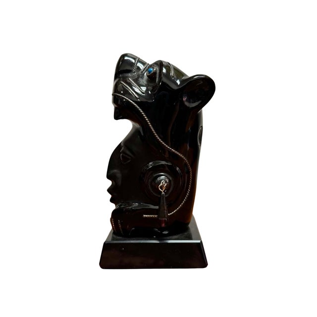 This striking vintage Mexican sculpture is hand carved from polished black obsidian and embellished with sterling silver...