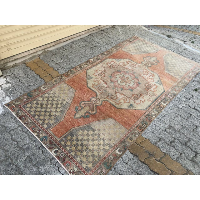 This is a vintage Turkish Oushak rug from the 1960s. The piece was hand-knotted.