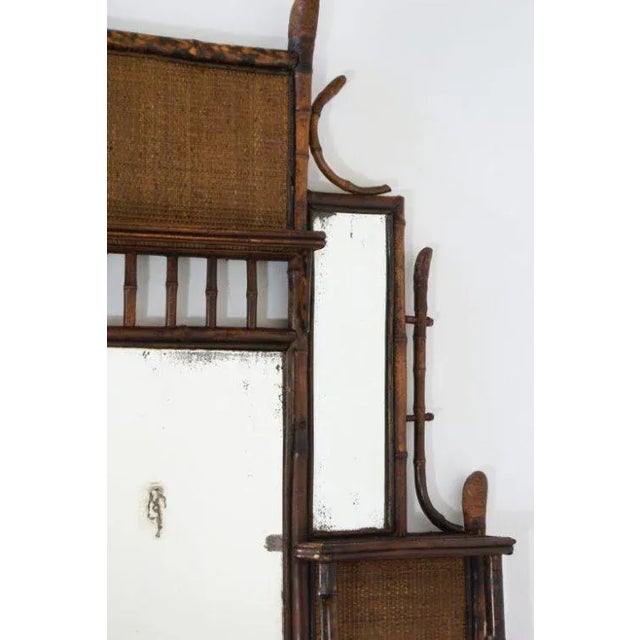 A nice late 19th century tortoise shell bamboo over mantel mirror with shelves. Good antique condition with wear and loss...