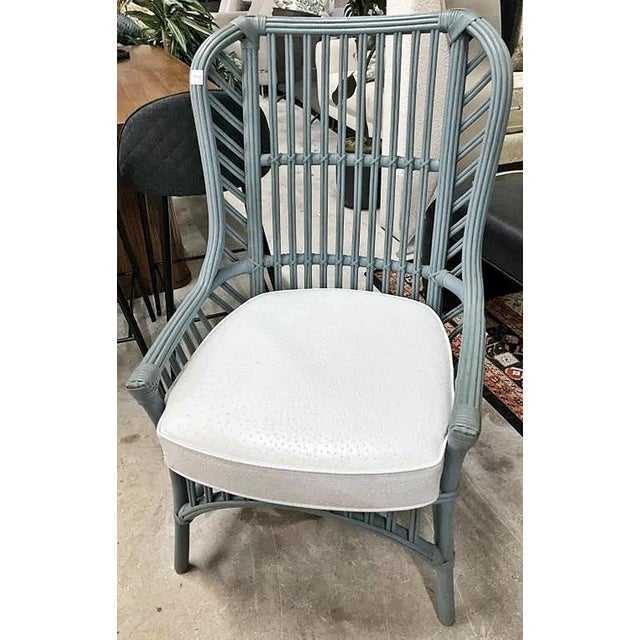 This vintage pair of Ficks Reed Rattan Wingback Chairs from the 1950-60s mid-century piece manufactured by the historic...