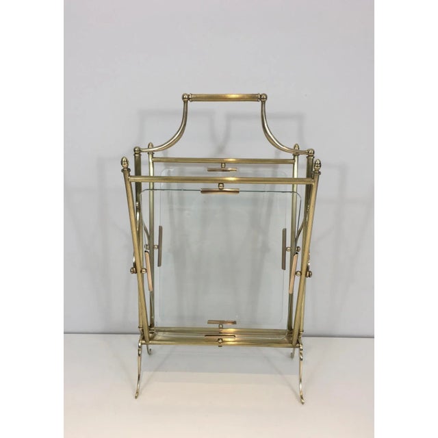 This neoclassical magazine rack is made of brass with a glass panel on each side. This piece is French and made of a nice...