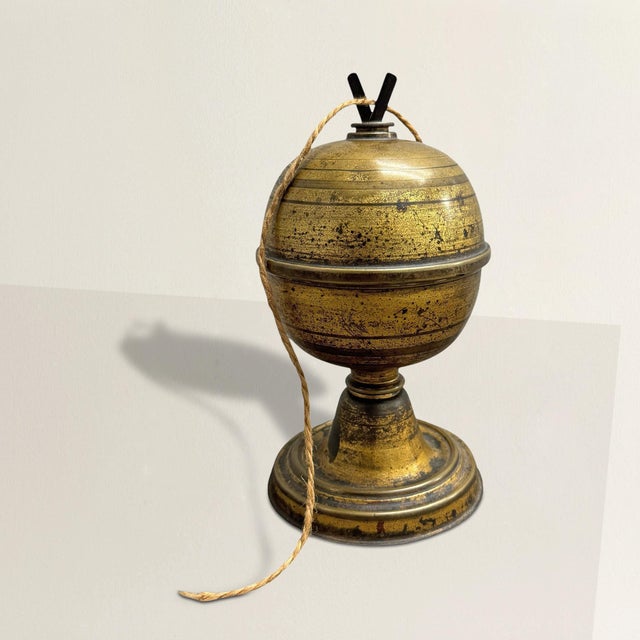 This 19th-century English string holder, once an essential tool in a bustling retail shop, exudes both charm and...