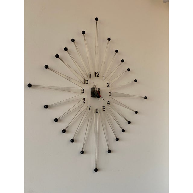 Very large and unusual vintage mid twentieth century starburst wall clock, cut from a sheet of 1/4" thick lucite, with a...