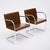 A sleek pair of mid-century modern armchairs featuring tubular chrome frames and beautifully toned cognac leather...