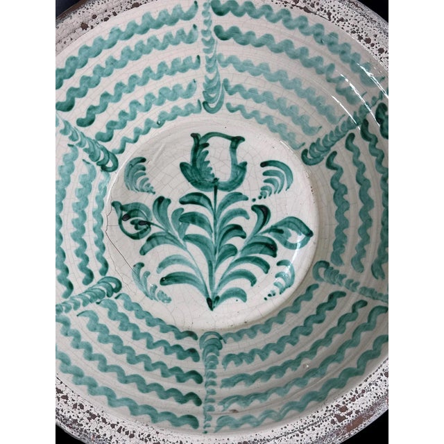 Striking large Fajalauza ceramic bowl from Granada, decorated with a central tulip surrounded by elegant foliate scrolls....