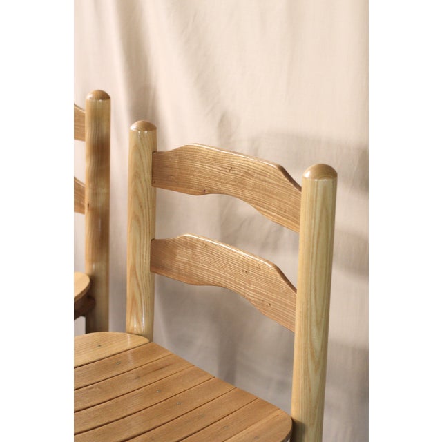 Set of 2 stools in the traditional style. Very midcentury. Blonde light wood in a great 80-90s style. Seats are nailed in...