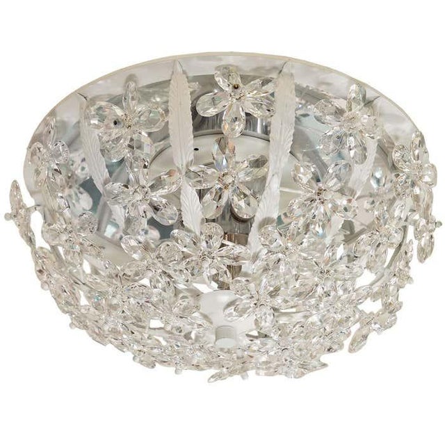 White enameled metal flush mount fixture with foliate motif and crystal flowers.