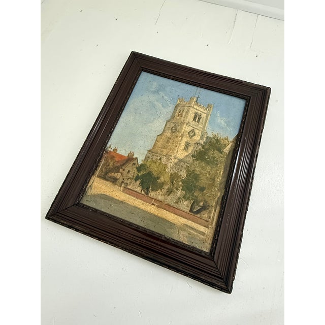 English architectural painting depicting a castellated church tower rising above a village street. Signed "John J. Fyson,...