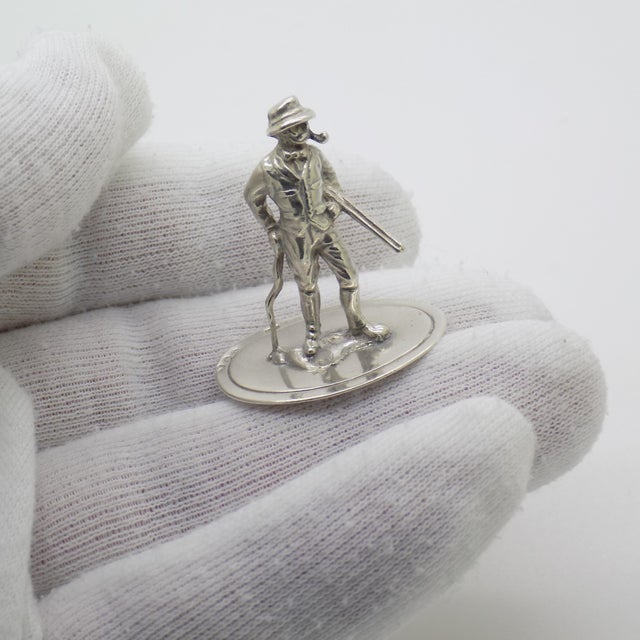 A vintage miniature depicting a country gentleman with a hunting theme, handcrafted in 835/000 silver in the netherlands...