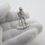 A vintage miniature depicting a country gentleman with a hunting theme, handcrafted in 835/000 silver in the netherlands...