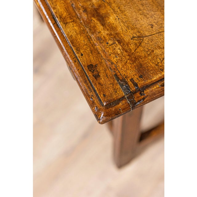 An Italian walnut side table from the 18th century with single drawer, carved apron and petite hoof feet. Born in Italy...