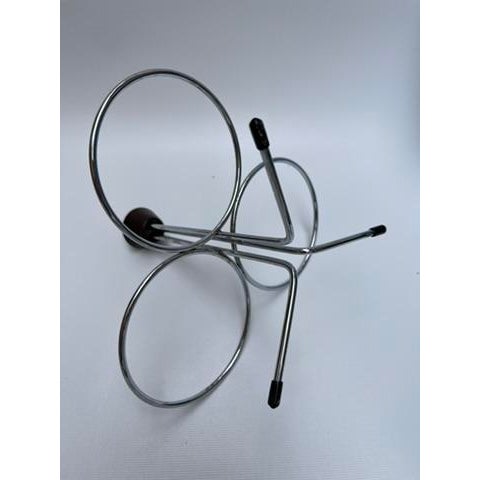 A vintage stainless steel and teak condiment serving set featuring a tripod stand, three bowls, and one spoon.