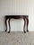This vintage Queen Anne-style console table features a shaped serpentine front, long cabriole legs, and carved detailing...