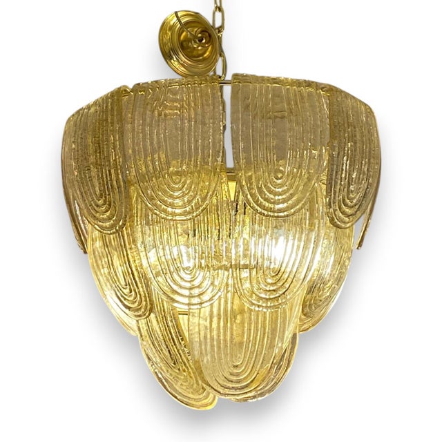 Fantastic Art Deco style pendant lamp with 3 tiers, made up of individual pieces of gilded Murano glass. Structure in...