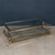 A striking Italian coffee table dating to the 1980s, executed in glass, brass and acrylic glass. The rectangular glass top...