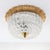 Original 1970s luxury wall or ceiling light with a unique glass design and a beautiful gold ring. The unique shape of the...